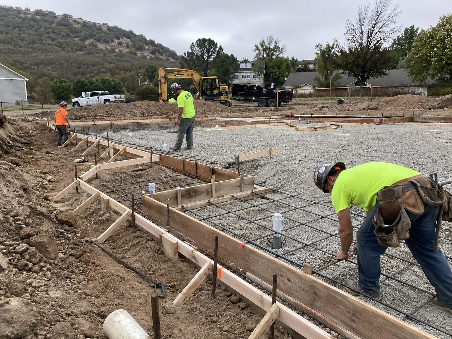Concrete foundation forms with rebar reinforcement — sitework preparation before pour