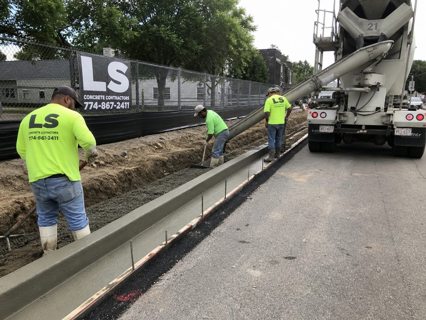 LS Concrete Contractors crew installing concrete curb and gutter on a commercial project