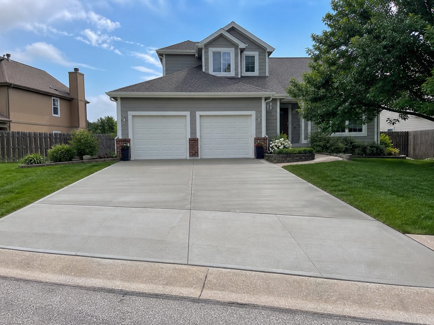 Finished residential concrete driveway in Lee's Summit, MO — strong curb appeal