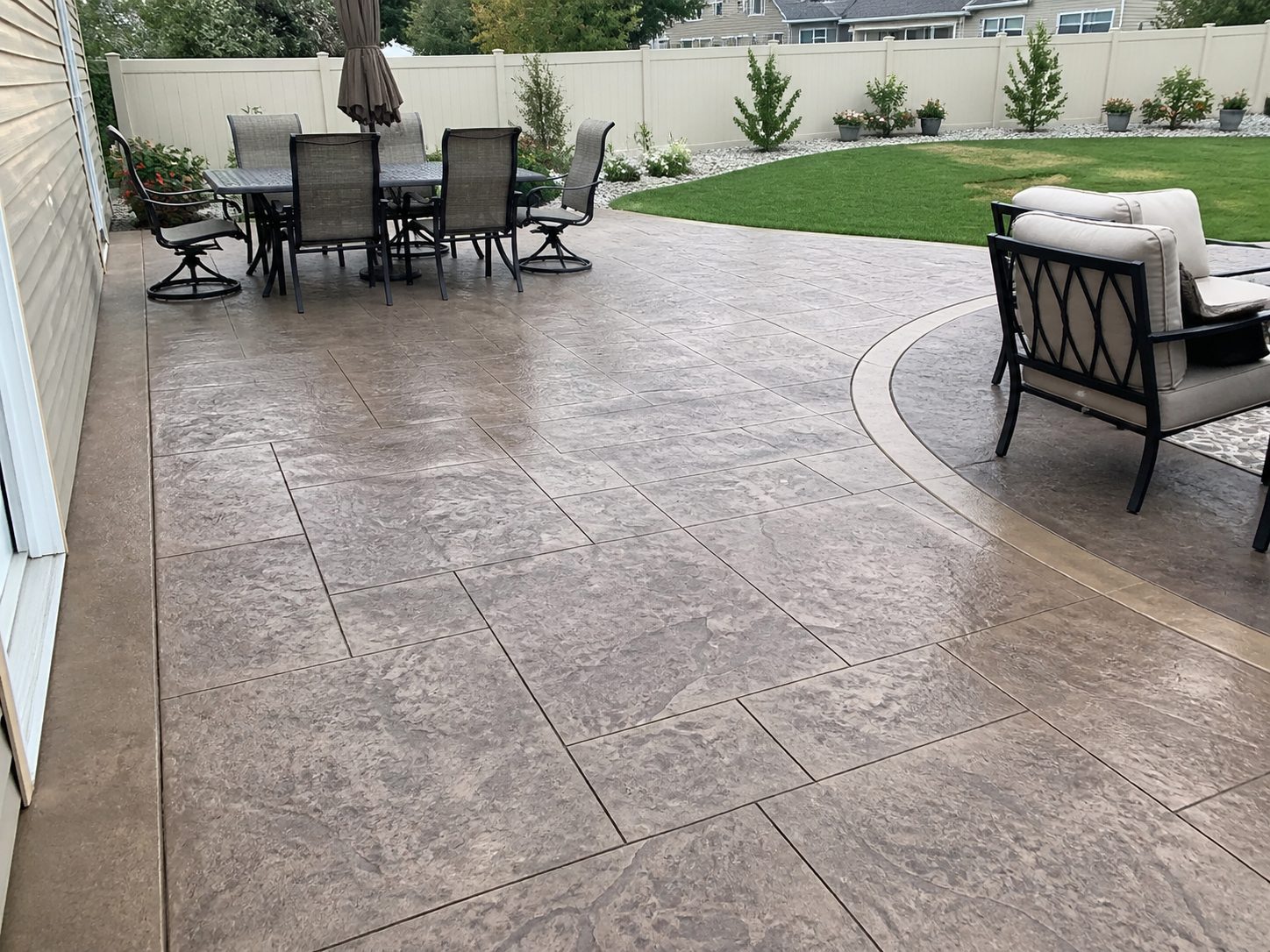 Stamped concrete patio with outdoor dining furniture — decorative finish
